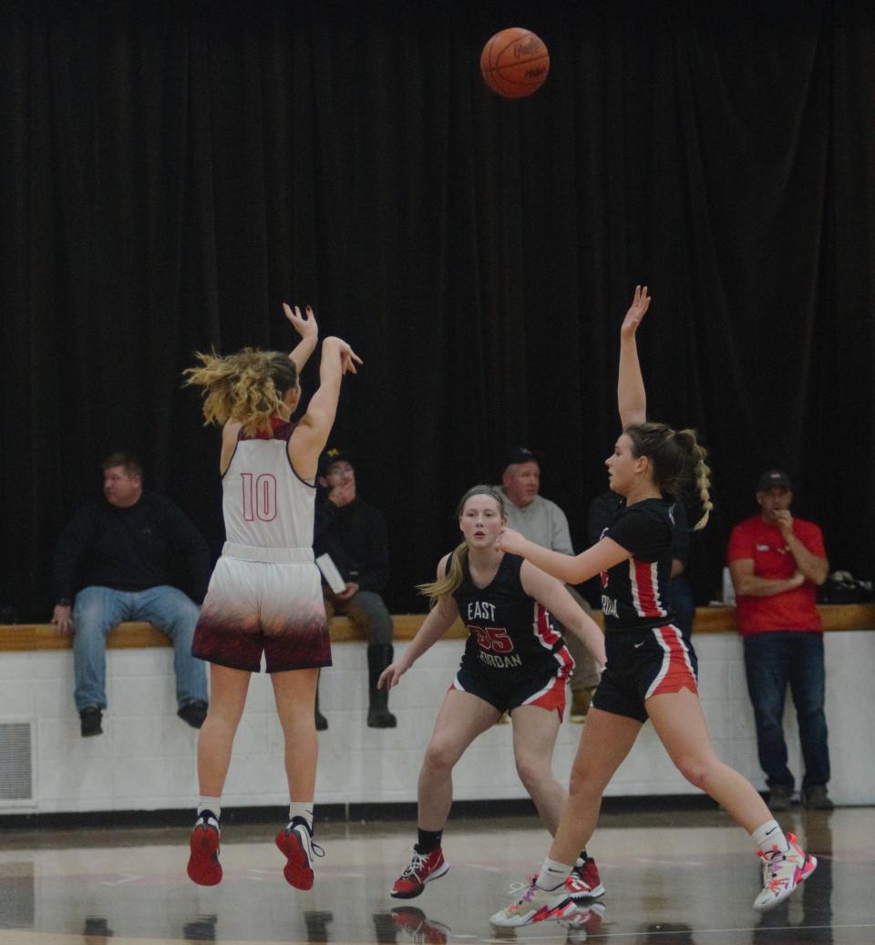 Sophia Townsend shoots a 3-pointer during a girls basketball matchup between Johannesburg-Lewiston and East Jordan on Thursday, December 2.