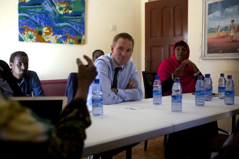 The British ambassador to Somalia, Neil Wigan, listens during a visit to a shelter for abused women in Mogadishu on February 18, 2015