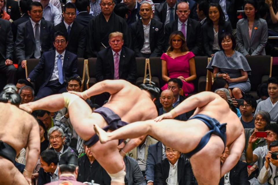 Trump and first lady Melania Trump are accompanied by Abe and his wife Akie Abe (centre row) as they watch a sumo demonstration.