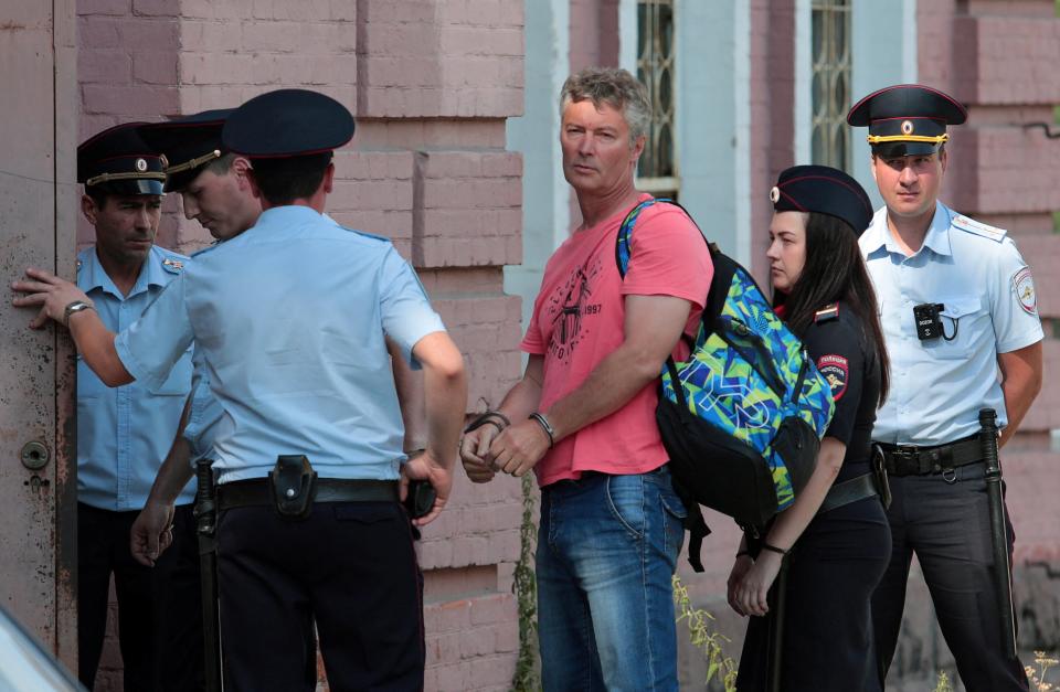 Kremlin critic Yevgeny Roizman is escorted to a court building in Yekaterinburg, Russia, on 25 August, 2022. (via REUTERS)