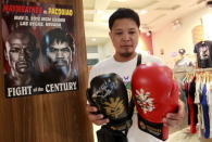 A fan looks at boxing gloves signed by boxer Manny Pacquiao of the Philippines, on sale for 4,000 Philippine pesos ($90) at a mall in Manila April 24, 2015. REUTERS/Romeo Ranoco