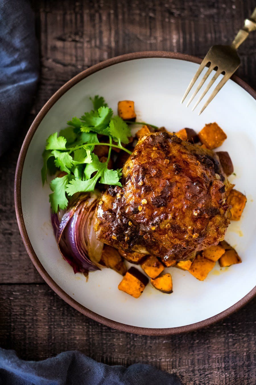 <strong>Get the <a href="https://www.feastingathome.com/sheet-pan-harissa-chicken/" target="_blank">Sheet Pan Harissa Chicken With Roasted Sweet Potatoes</a> recipe from Feasting At Home</strong>