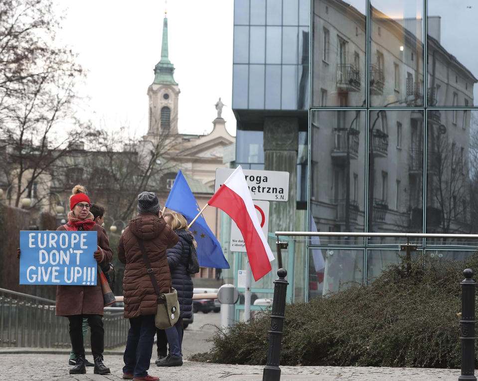 FILE - In this Jan. 28, 2020, file photo, demonstrators protest against Poland's government's efforts to control the court system in front of the Supreme Court in Warsaw, Poland. The European Union still hasn't completely sorted out its messy post-divorce relationship with Britain — but it has already been plunged into another major crisis. This time the 27-member union is being tested as Poland and Hungary block passage of its budget for the next seven years and an ambitious package aimed at rescuing economies ravaged by the coronavirus pandemic. (AP Photo/Czarek Sokolowski, File)