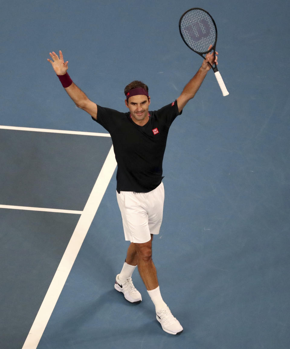 Switzerland's Roger Federer celebrates after defeating Australia's John Millman in their third round match at the Australian Open tennis championship in Melbourne, Australia, Saturday, Jan. 25, 2020. (AP Photo/Dita Alangkara)