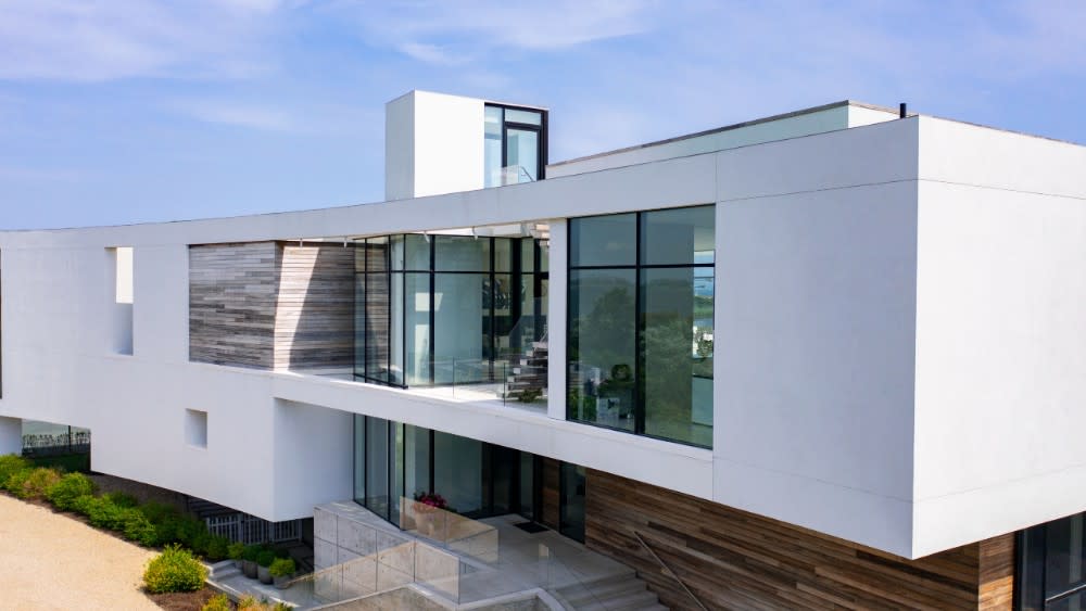 The modern home has a sleek curved exterior. - Credit: The Corcoran Group