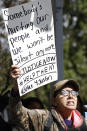 Ann Adams, calls attention to the plight of her incarcerated son, who she alleges does not receive the proper food to accompany his medication, at a mass gathering in front of the Mississippi Capitol in Jackson, on Friday, Jan. 24, 2020, protesting alleged unsanitary and dangerous conditions in prisons where inmates have been killed in violent clashes in recent weeks. (AP Photo/Rogelio V. Solis)