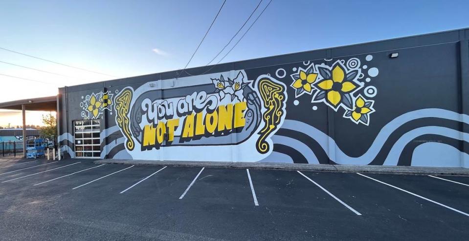 Elisa Del Giudice’s “You Are Not Alone,” a mural on the Plum Street YMCA, is part of an international project meant to create hope and connection and raise awareness of mental health issues.