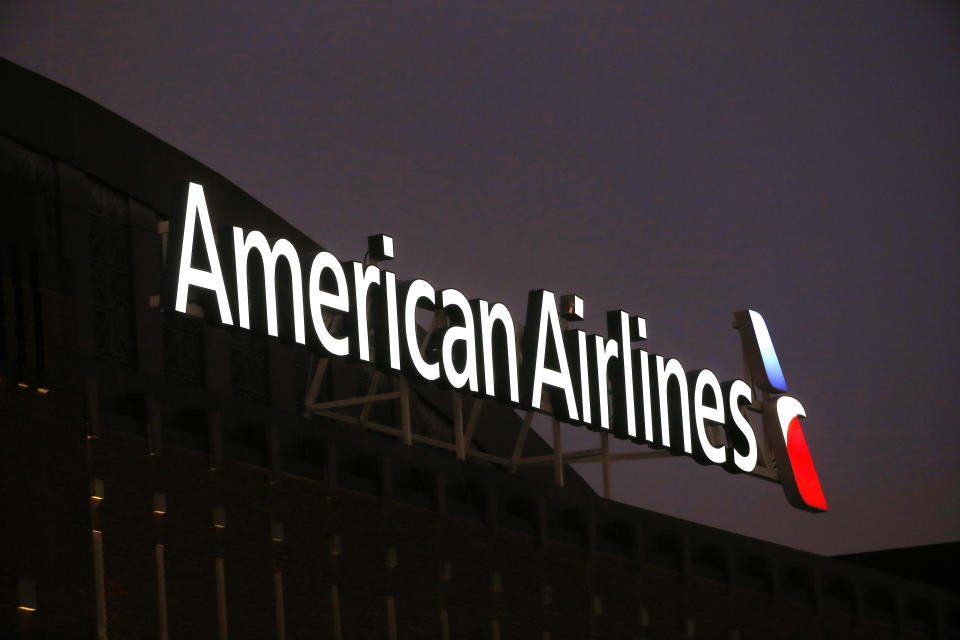 FILE - The American Airlines logo on top of the American Airlines Center in Dallas, Texas, is pictured on Dec. 19, 2017. Federal investigators said Thursday, March 16, 2023, that an air traffic controller cleared a plane to take off from Sarasota, Fla., while an American Airlines jet was making its final approach to the same runway last month, leading the American pilots to abandon their landing. (AP Photo/Michael Ainsworth, File)