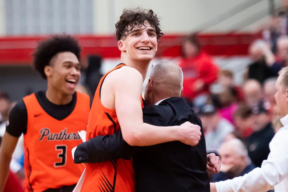 Central York junior Ben Rill hugs head coach Jeff Hoke near the end of a PIAA Class 6A basketball semifinal against Reading at Warwick High School on March 19, 2024, in Lititz. The Panthers won, 79-65, to advance to the championship game.