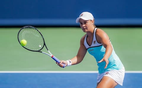 Ashleigh Barty, of Australia, returns to Maria Sakkari - Credit: AP