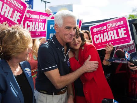 Former Florida Governor and Democratic gubernatorial candidate Charlie Crist hugs his running mate Annette Taddeo (R) during the first stop of his state-wide bus tour in Miami, Florida November 3, 2014. REUTERS/Scott Audette