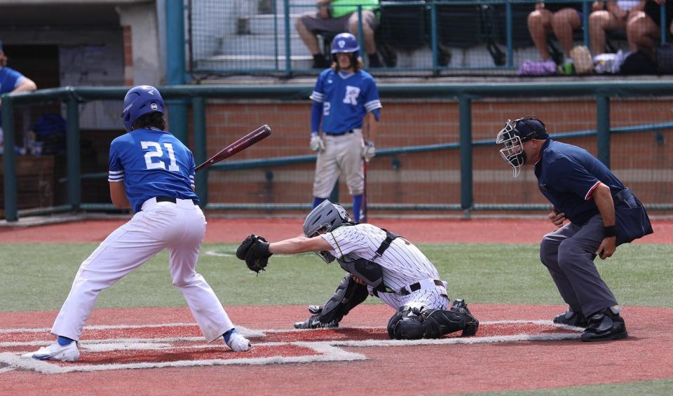 Reading senior Joel Steinkoenig checks his swing against Roger Bacon's pitching in the June 2 Division II regional semifinal game.