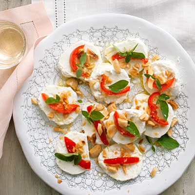 <div class="caption-credit"> Photo by: Lisa Romerein</div><div class="caption-title">Goat Cheese with Peppers and Almonds</div><b>Goat Cheese with Peppers and Almonds</b> <br> Just slice and serve a few refined ingredients and you're ready to mingle. <br> <b>Pair with:</b> Sparkling rosé, Pinot Grigio, Riesling, or Pinot Noir <br> <b>Recipe:</b> <br> Ingredients <br> <ul> <li>8 ounces log fresh goat cheese (chevre) </li> <li>5 Peppadew peppers*, cut in half and thinly sliced </li> <li>20 Marcona almonds </li> <li>1 tablespoon fresh oregano leaves </li> <li>3 tablespoons extra-virgin olive oil, for drizzling </li> <li>Crackers </li> </ul>Preparation <br> Slice cheese into rounds about 1/2 in. thick, dipping the knife into hot water between slices and wiping it clean. Arrange slices on a plate and sprinkle with peppers, almonds, and oregano leaves. Drizzle with olive oil and serve with crackers. <br> *Find in the olive bar at well-stocked grocery stores. <br>