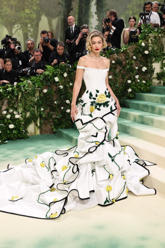 <p>Jamie McCarthy/Getty Images</p><p>A perennial Met Gala attendee, the supermodel wore a flowing white gown with yellow flowers embroidered on it. </p>