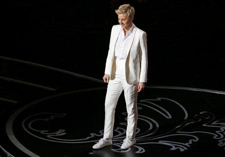 Host Ellen Degeneres stands on stage at the 86th Academy Awards in Hollywood, California March 2, 2014. REUTERS/Lucy Nicholson