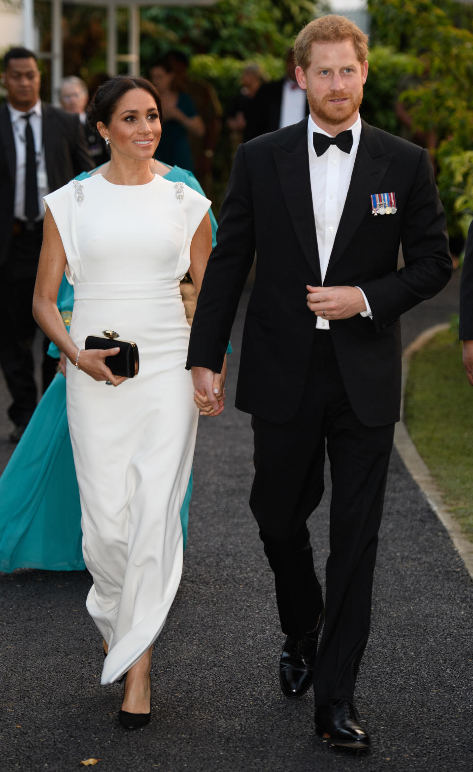 <p>For an evening reception in Tonga, the mother-to-be chose a white gown by Theia Couture with Aquazzura shoes, Birks earrings and her go-to Givenchy clutch. In a touching nod to Princess Diana, the Duchess finished the ensemble with the late royal’s aquamarine ring. <em>[Photo: Getty]</em> </p>