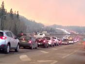 At least half of the city of Fort McMurray in northern Alberta was under an evacuation notice Tuesday as a wildfire whipped by winds engulfed homes and sent ash raining down on residents. THE CANADIAN PRESS/HO-CAOS91.1(KAOS)