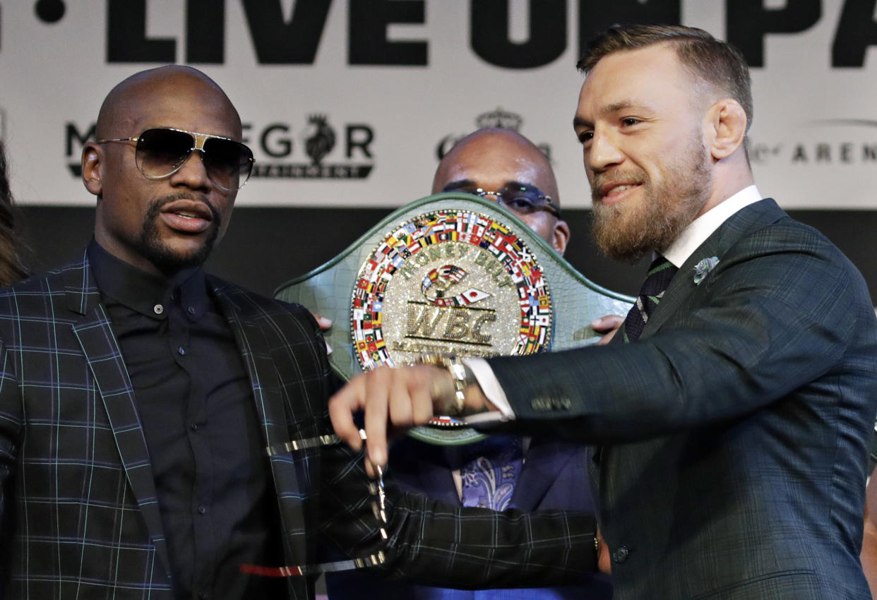 Floyd Mayweather Jr., left, and Conor McGregor pose for photographers during a news conference Wednesday, Aug. 23, 2017, in Las Vegas. The two are scheduled to fight in a boxing match Saturday in Las Vegas. (AP Photo/John Locher)