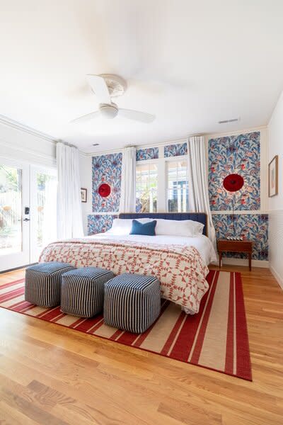 In the primary ensuite bedroom, the wallpaper is from Mind the Gap, the wall lighting is from Hay, and the nightstands are from Design Bank in Durham.