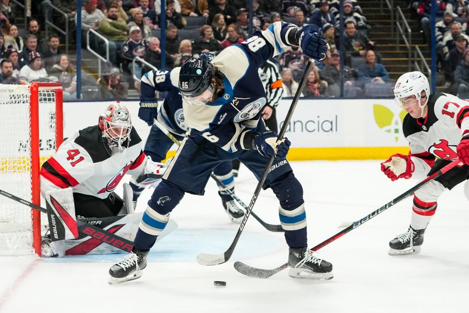 Jan 19, 2024; Columbus, Ohio, USA; Columbus Blue Jackets right wing Kirill Marchenko (86) passes between his legs in front of New Jersey Devils goaltender Vitek Vanecek (41) during the first period of the NHL hockey game at Nationwide Arena.