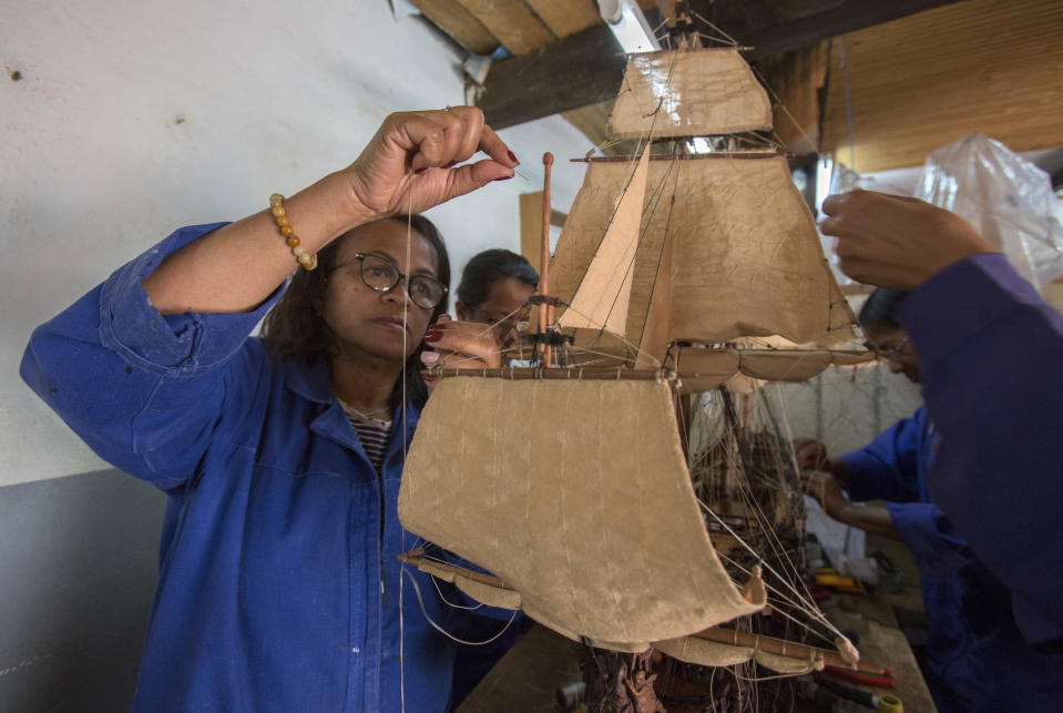 Malagasy women build a model ship at the Le Village model ship making company in Antananarivo, Madagascar, Wednesday, Sept. 11, 2024. (AP Photo/Alexander Joe)