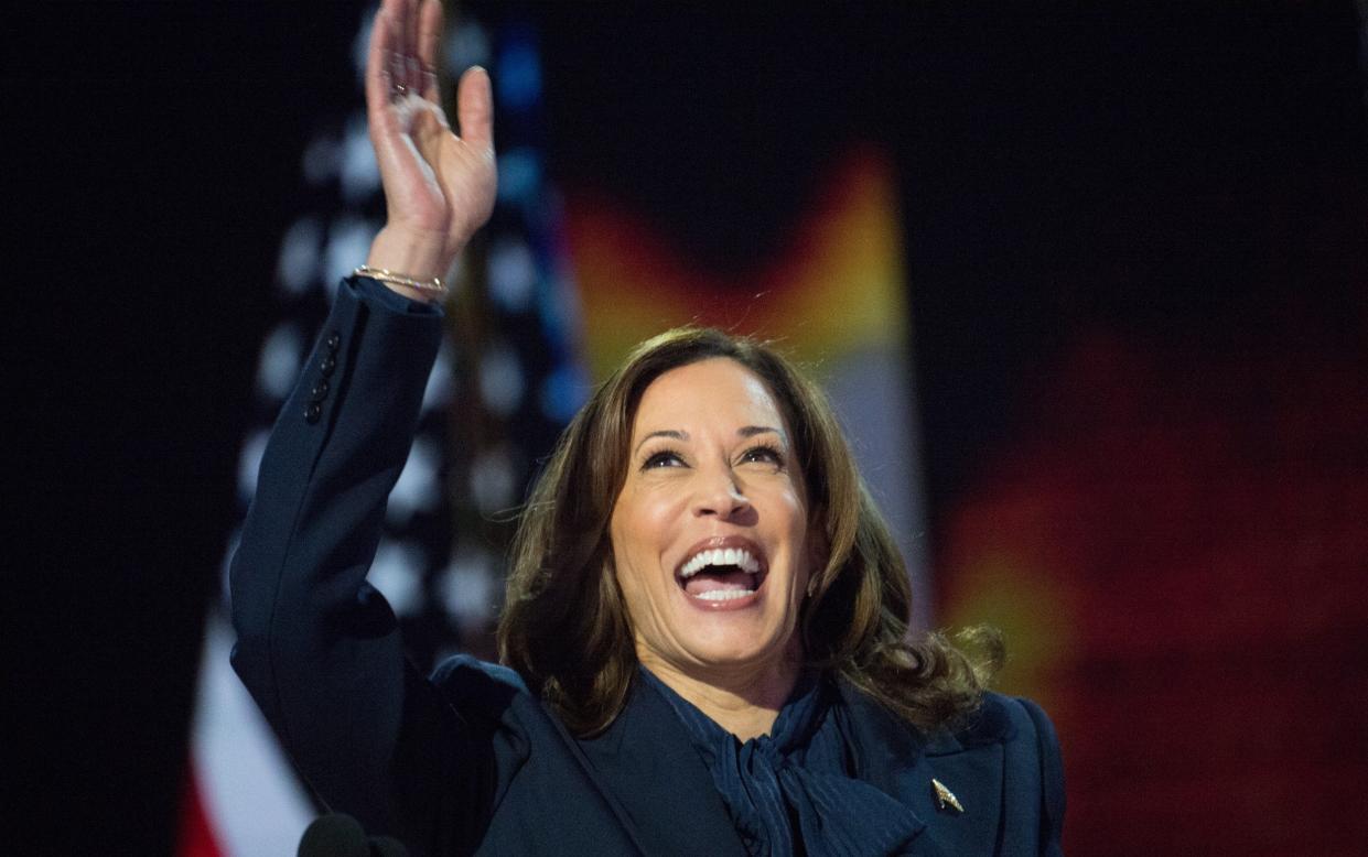 US Vice President Kamala Harris greets as she speaks during the Democratic National Convention