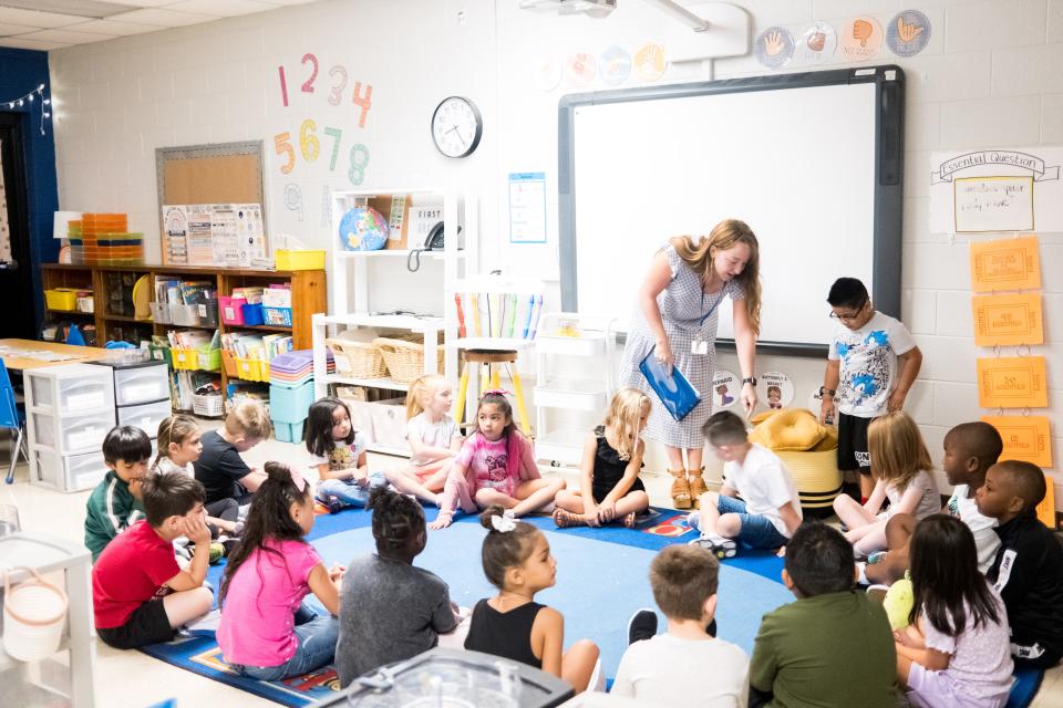 Maggie Arnold shows her first grade students where and how they will sit when called up to the front of her class during the first day back at Riverside Elementary School in Columbia, Tenn. on Monday, Aug. 7, 2023.