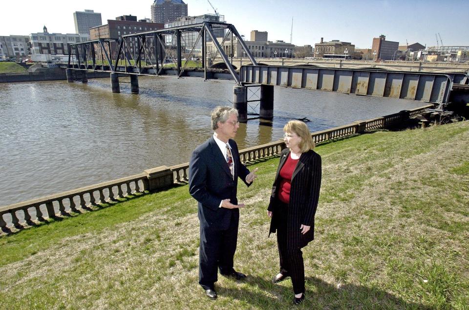 Des Moines Mayor Frank Cownie, left, talks with Mary O'Keefe, then Principal senior vice president and chief marketing officer, near the railroad bridge over the Des Moines River in 2004. The bridge was scheduled to be one of the first phases to be completed of the Principal Riverwalk project.