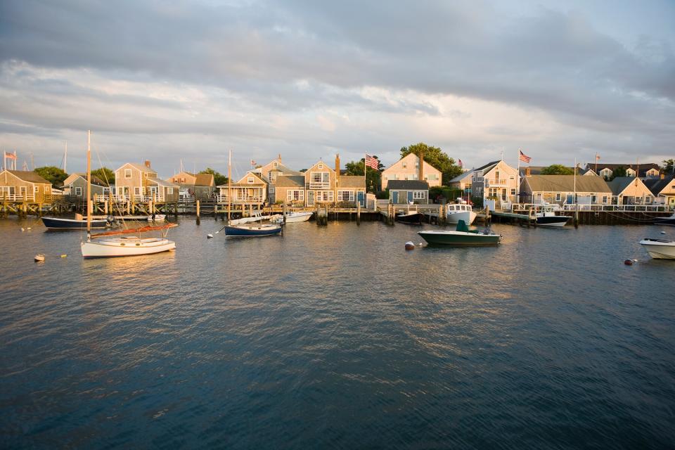 Boats in harbor with village in background of Nantucket