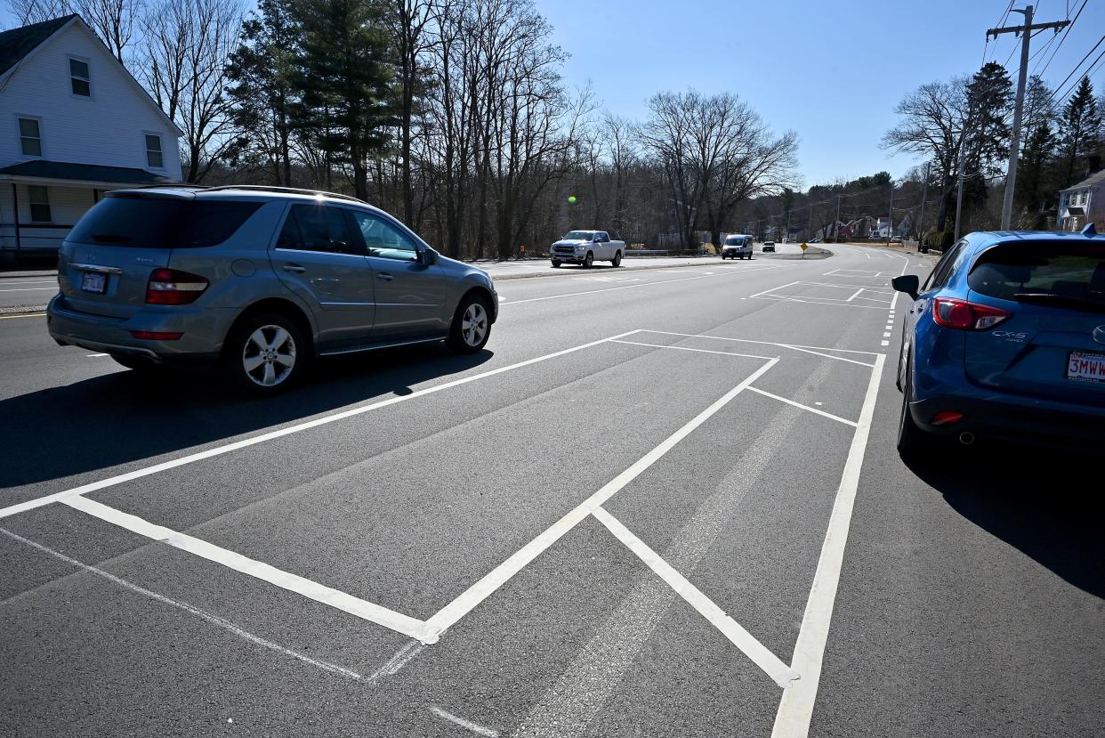 On Mill Street, a car is parked in the bicycle lane instead of the designated parking spaces in the road.