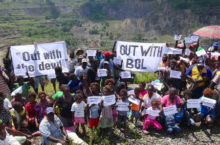 A supplied image shows local residents holding banners and placards during a protest at the former Bougainville Copper Limited's (BCL) Panguna mining operation located on the Pacific Ocean island of Bougainville, Papua New Guinea, May 3, 2017. Picture taken May 3, 2017. Renzie Duncan/Handout via REUTERS