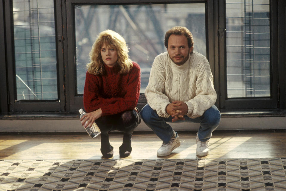 Meg Ryan and Billy Crystal crouching.