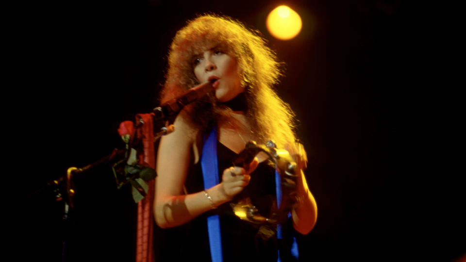 American singer Stevie Nicks of the group Fleetwood Mac sings and plays the tambourine on stage during the Tusk Tour on May 24, 1980 at the Joe Louis Arena in Detroit, Michigan