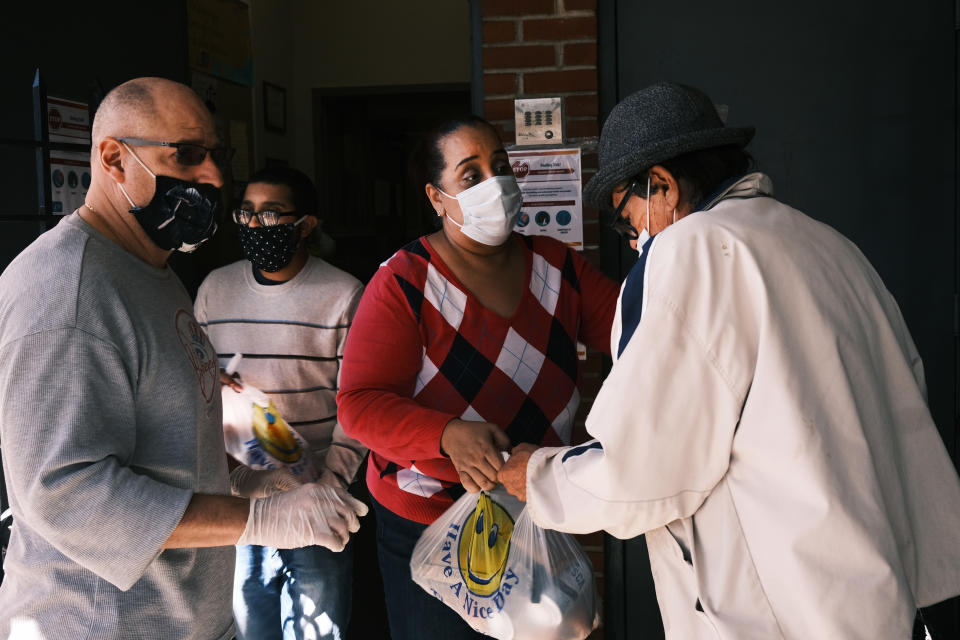 NEW YORK, NEW YORK - OCTOBER 17: People receive food at the Thessalonica Christian Church during a distribution site on October 17, 2020 in New York City. The Bronx, a borough which has long struggled with poverty and neglect, has been especially impacted by the COVID-19 pandemic. The official unemployment rate in the Bronx is 21% while the unofficial number is presumed to be almost twice that. With many residents unable to afford health care and being home to a significant amount of front-line workers, the Bronx has the highest COVID-19 death rate in New York City.  (Photo by Spencer Platt/Getty Images)