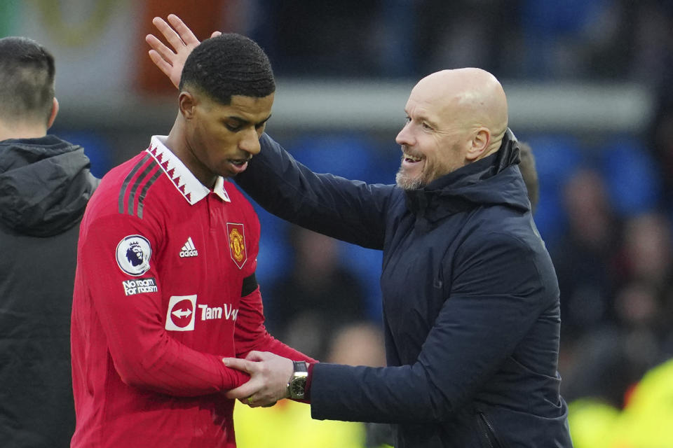 Manchester United's head coach Erik ten Hag congratulates with Marcus Rashford as he leaves the pitch during the English Premier League soccer match between Leeds United and Manchester United at Elland Road, Leeds, England, Sunday, Feb.12, 2023. (AP Photo/Jon Super)