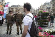 FILE - In this June 19, 2016 file photo, Belgian Army soldiers patrol in the historic Grand Place in Brussels. Surveillance continues since the attacks of March 22, 2016, and Belgium continues to live under the second-highest terror level. (AP Photo/Virginia Mayo, File)