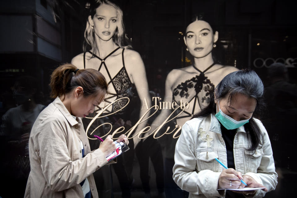 People write Christmas cards for detained and jailed protesters during a rally in Hong Kong, Monday, Dec. 16, 2019. China's premier said Monday that turmoil over amendments to extradition legislation has damaged Hong Kong society on all fronts. (AP Photo/Mark Schiefelbein)