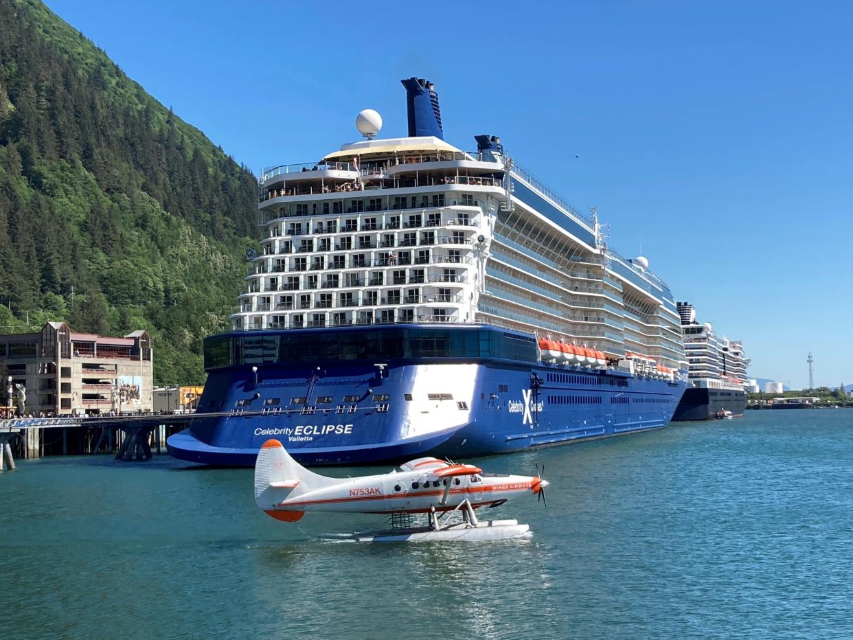 A floatplane taxis near docked cruise ships as it prepares to take off on July 6, 2023, in the Gastineau Channel, along the downtown waterfront in Juneau, Alaska.