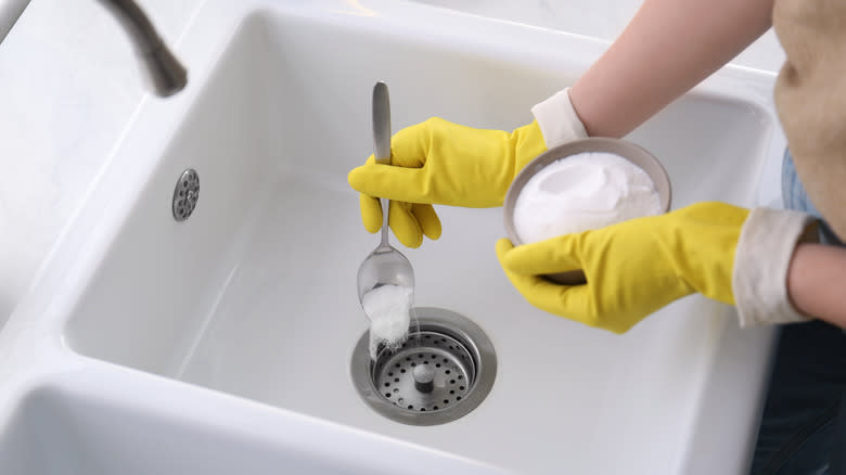 Kitchen sink being cleaned with baking soda