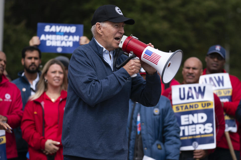 FILE - President Joe Biden speaks to striking United Auto Workers on the picket line outside the Willow Run Redistribution Center, UAW Local 174, Sept. 26, 2023, in Van Buren Township, Mich. Biden will be the keynote speaker Wednesday, Jan. 24, at a UAW political convention as he works to sway blue-collar workers his way in critical auto-making swing states such as Michigan and Wisconsin. (AP Photo/Evan Vucci, File)