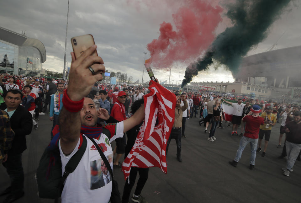 <p>Moroccan fans light smoke bombs in front of Saint Petersburg stadium prior to the match. (AP) </p>