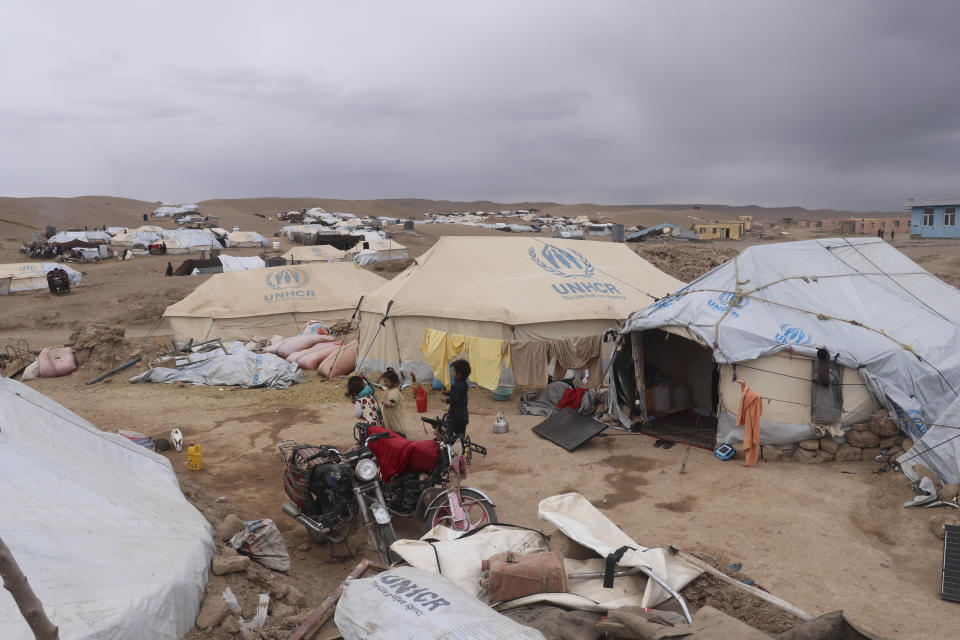 Afghan children walk through a tent camp in Zindan Jan, Afghanistan, on Thursday, Jan. 4, 2024, three months after a massive earthquake hit the area. (AP Photo/ Omid Haqjo)