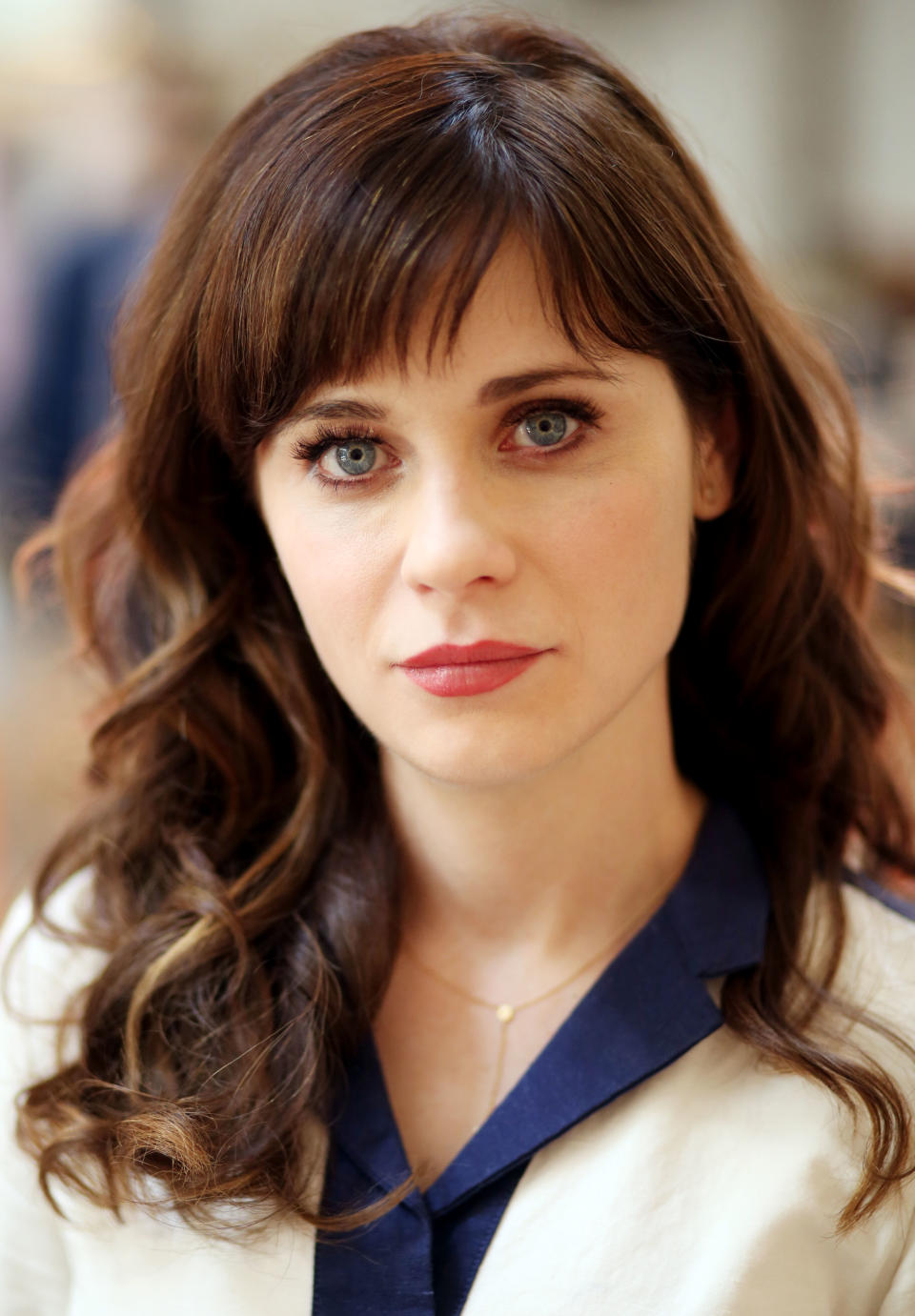 Zooey Deschanel poses for a portrait in Los Angeles on Wednesday, April 9, 2014. Deschanel collaborated with designer Tommy Hilfiger on the "To Tommy, From Zooey" collection. A self-described “fabric nerd” known for her bright blue eyes, long bangs and retro-inspired dresses, Deschanel spent two years collaborating with Hilfiger to create a collection of flirty frocks based on her own personal style. (Photo by Matt Sayles/Invision/AP)