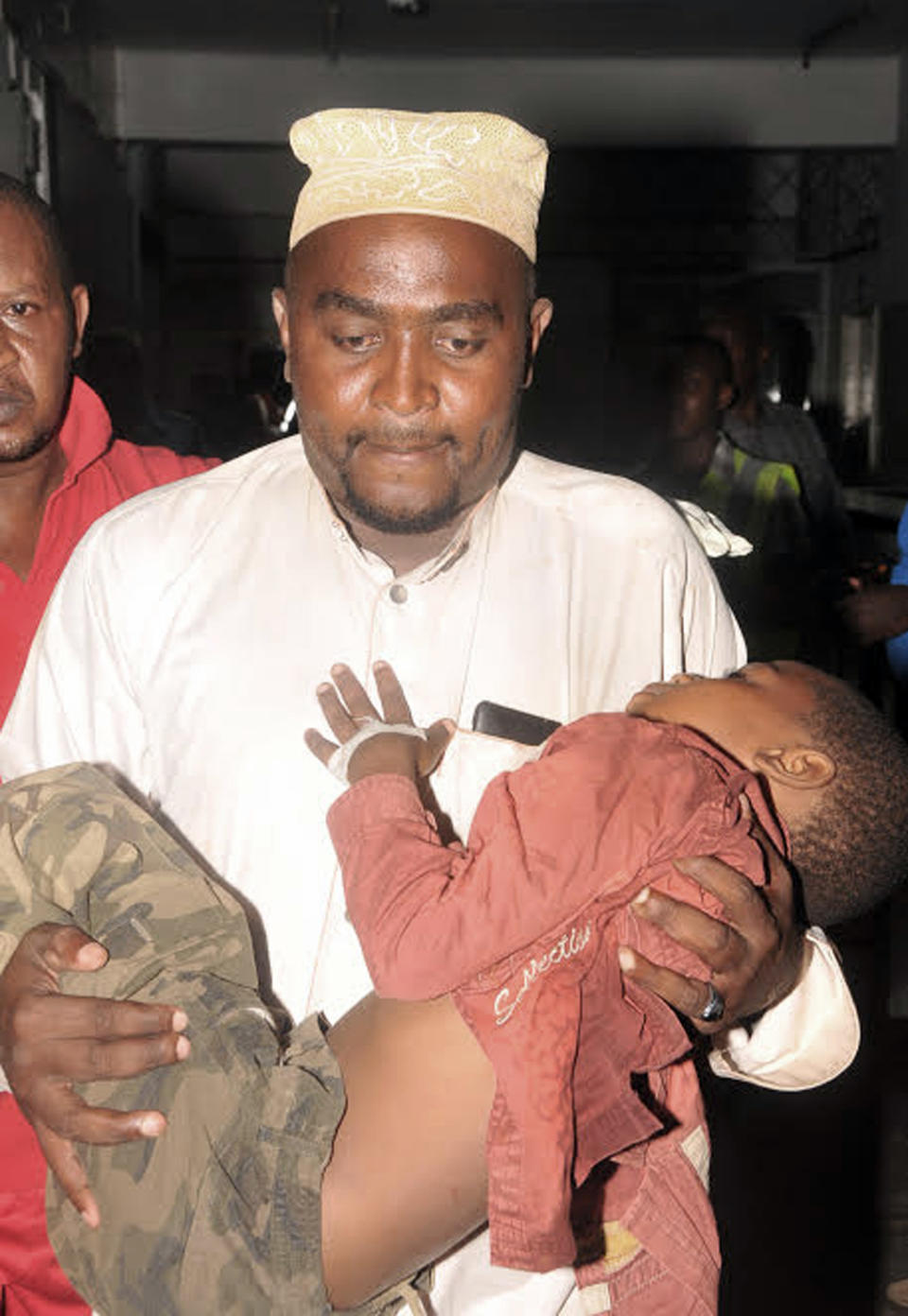 An injured child is carried to hospital in Mombasa Kenya, Saturday, May, 3, 2014. At least three have been confirmed dead and several others injured in twin explosions in the coastal city of Mombasa, Kenya, police said on Saturday. Mombasa Country police commander, Robert Kitur said they have not established the cause of the explosions at Reef Hotel Nyali and Mwembe Tayari in town. (AP Photo)