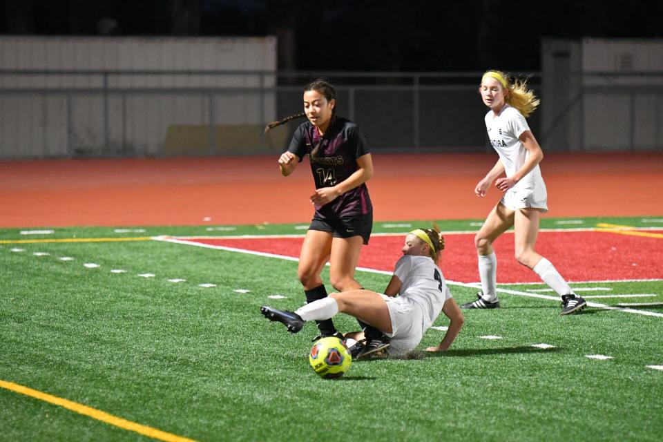 Oxnard senior Malia Tarazon is tackled by Ventura junior Esja Moore during the host Yellowjackets' 3-2 win over the Cougars on Jan. 13.