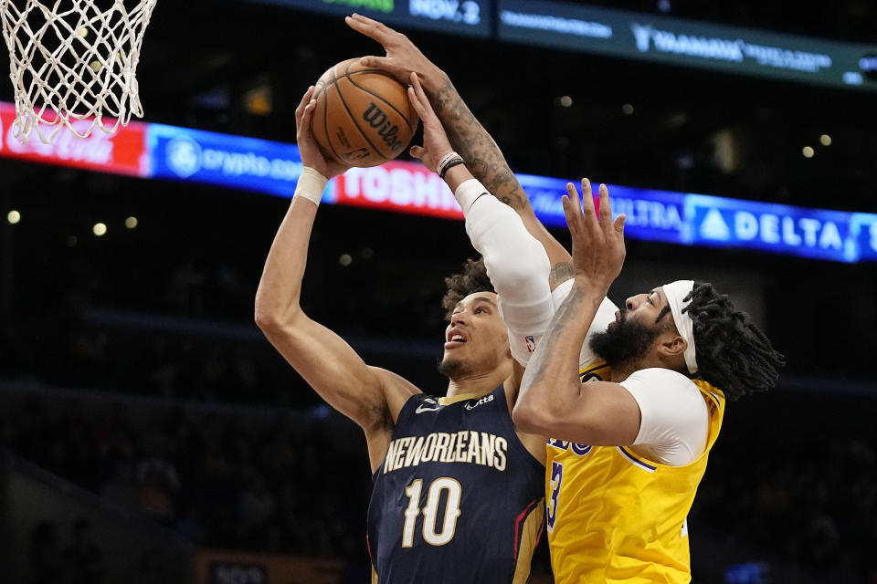 New Orleans Pelicans center Jaxson Hayes, left, shoots as Los Angeles Lakers forward Anthony Davis defends during the first half of an NBA basketball game Wednesday, Nov. 2, 2022, in Los Angeles. (AP Photo/Mark J. Terrill)