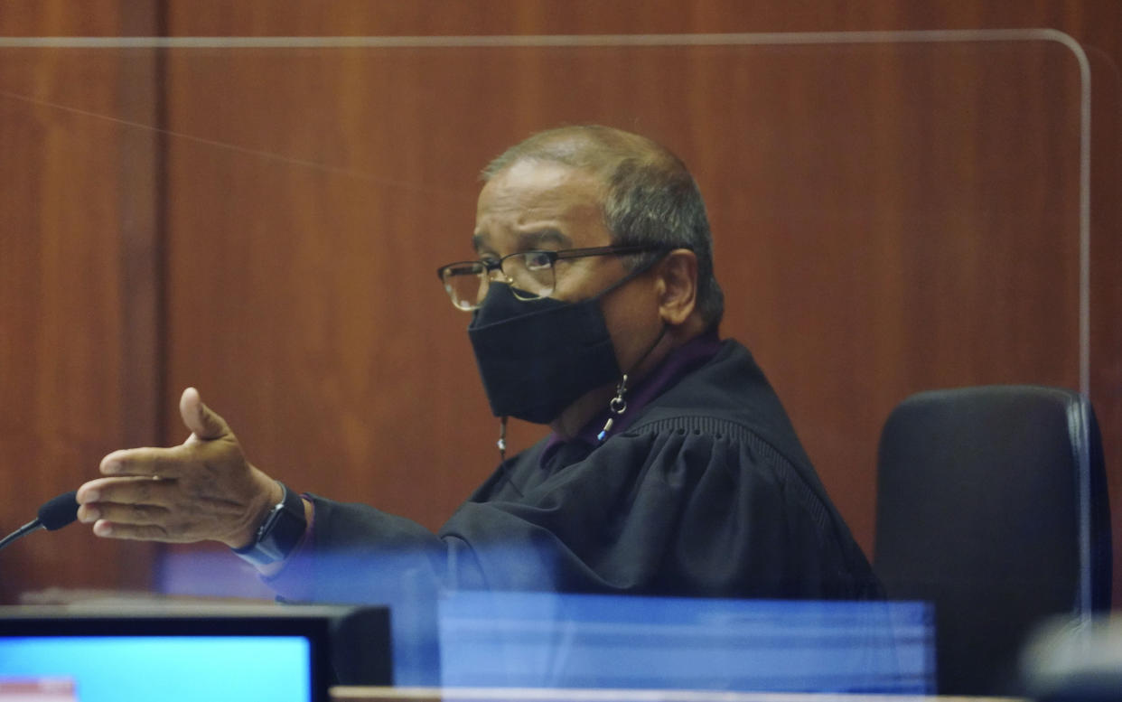 FILE - Judge William Domingo presides over a preliminary hearing as he hears from witnesses to determine whether there is probable cause for murder and attempted murder charges against three Honolulu police officers in a shooting that killed a 16-year-old Micronesian boy, Tuesday, July 20, 2021, in Honolulu. Domingo on Wednesday, Aug. 18 rejected murder and attempted murder charges against officers, preventing the case from going to trial. (Cory Lum/Honolulu Civil Beat via AP, Pool, File)
