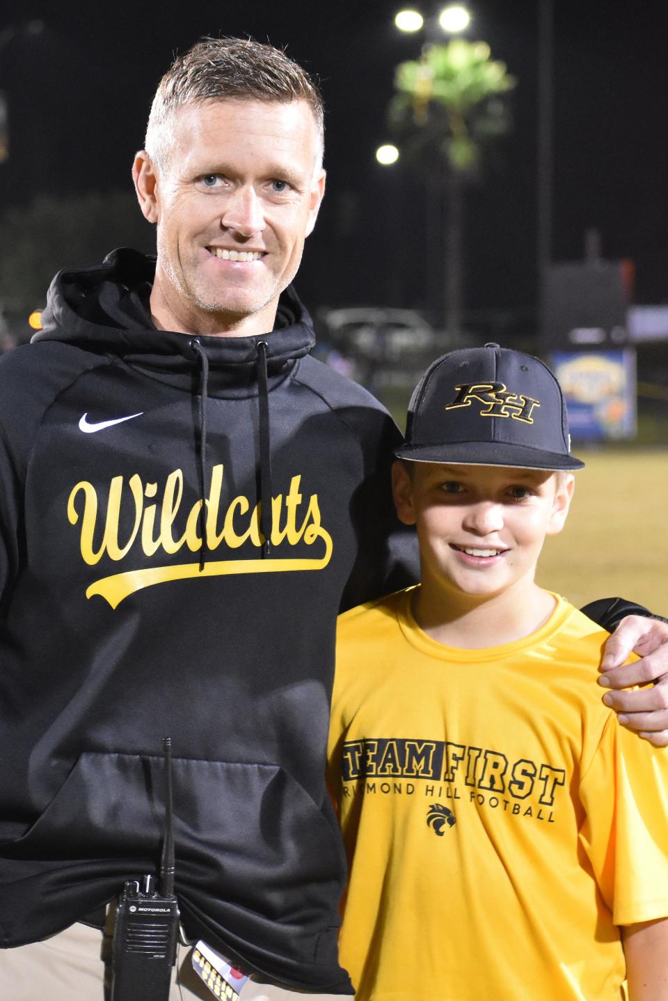 Stacy Bennett, shown with his son Brody following a Richmond Hill High School football game in fall 2021, is the new athletic director for the Wildcats.