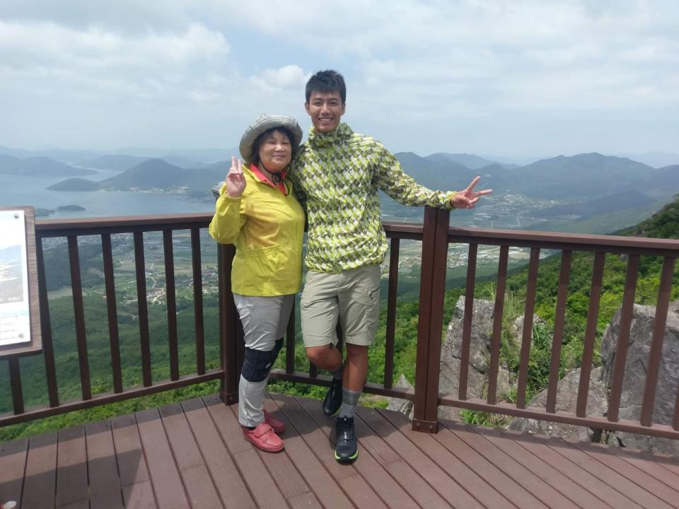 賴東賢（右）從小由阿嬤帶大，主持《愛玩客》時，祖孫倆一起到韓國巨濟島出外景。（鴻言娛樂提供）