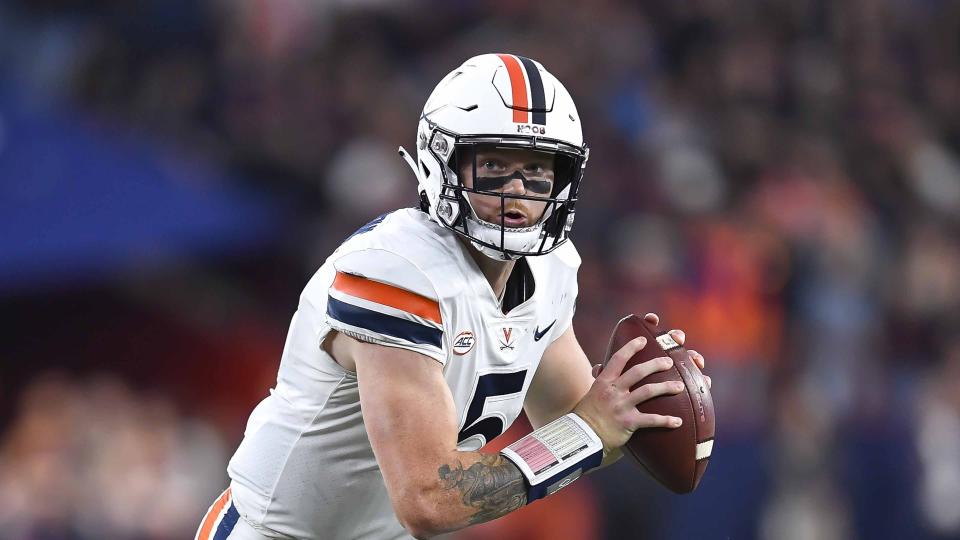 Virginia quarterback Brennan Armstrong (5) runs with the ball during the second half of an NCAA college football game against Syracuse on Friday, Sept. 23, 2022 in Syracuse, N.Y. (AP Photo/Adrian Kraus)